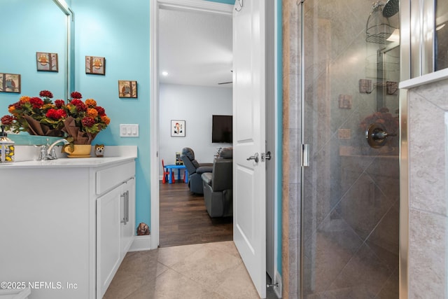 bathroom with vanity, an enclosed shower, and tile patterned floors