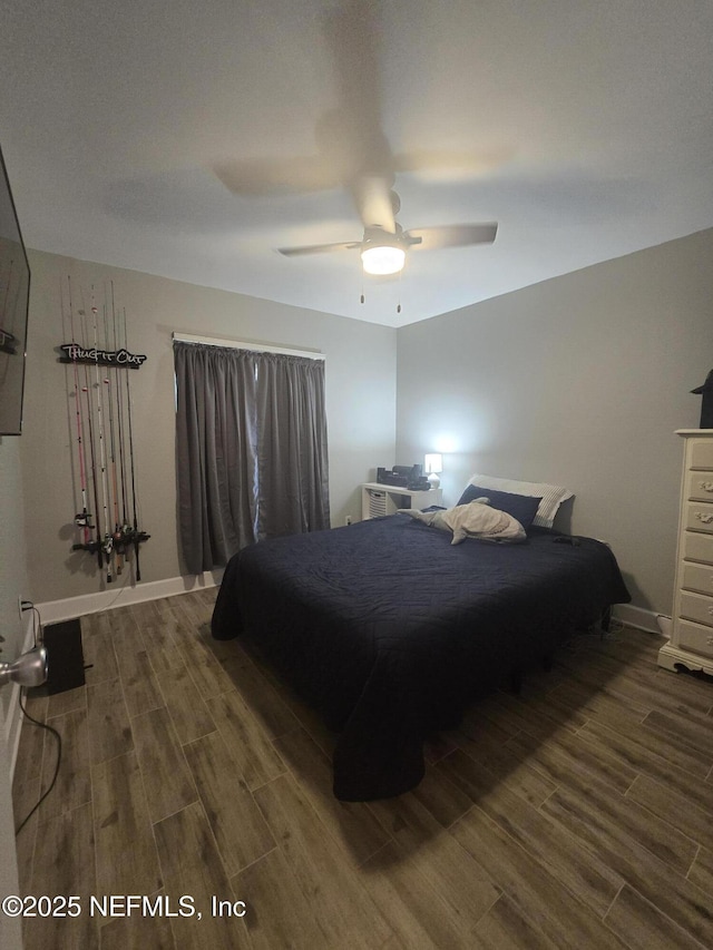 bedroom featuring dark hardwood / wood-style flooring and ceiling fan