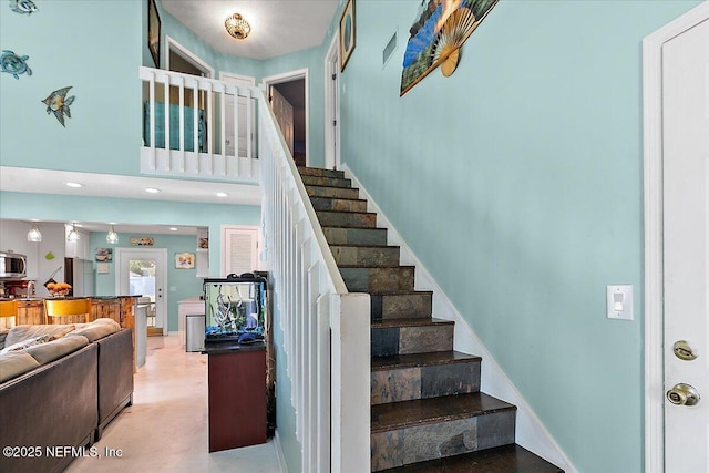 stairway with a towering ceiling