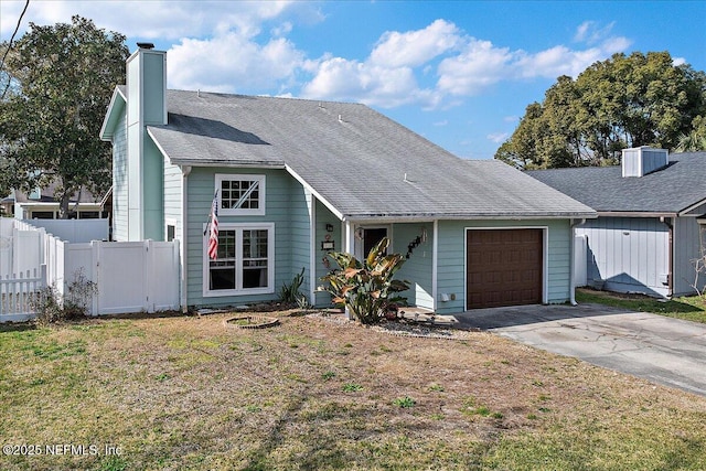 view of front of home with a garage and a front lawn