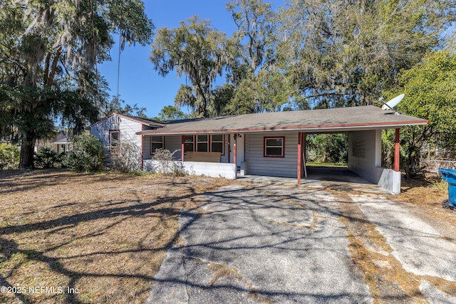 ranch-style home featuring a carport