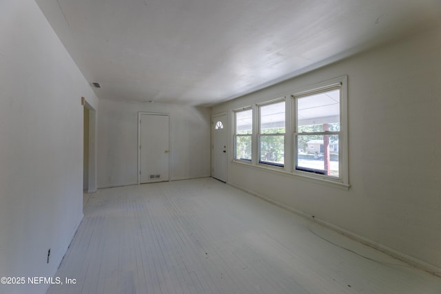 unfurnished room with light wood-type flooring