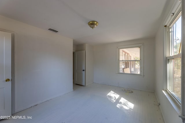 empty room with light hardwood / wood-style flooring