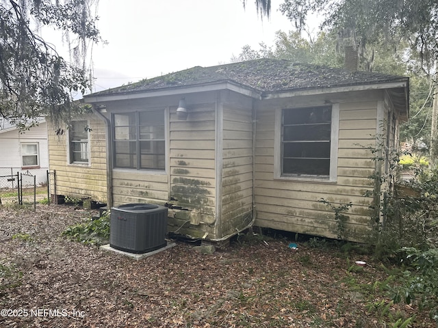 view of side of property featuring central AC