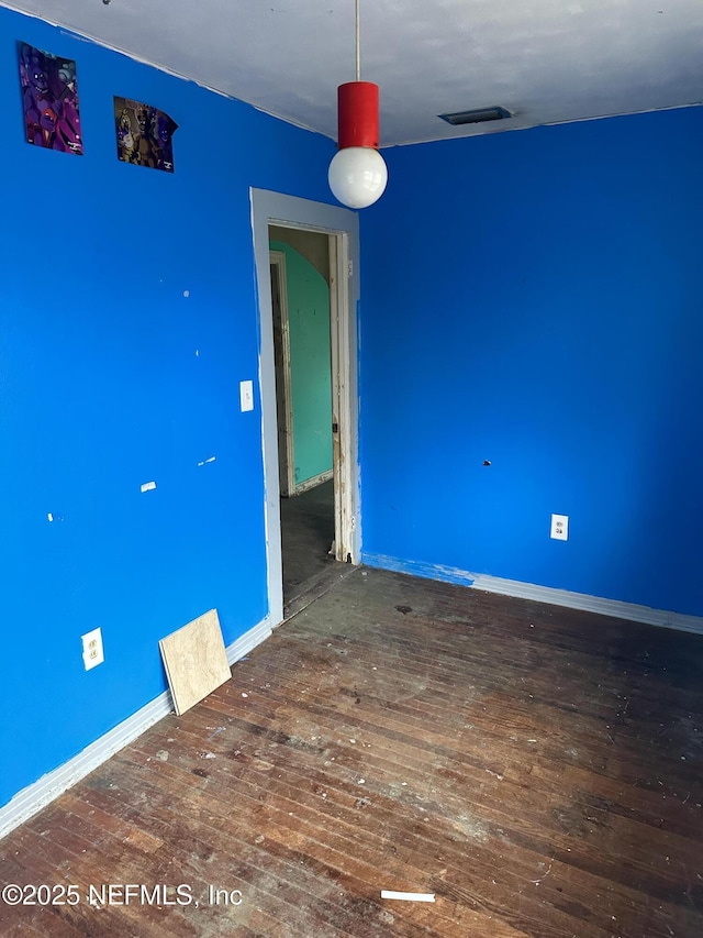 spare room with dark wood-type flooring