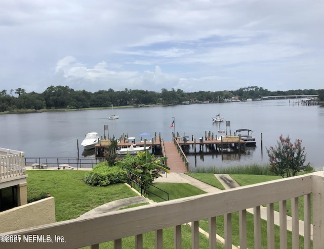 dock area with a water view and a lawn