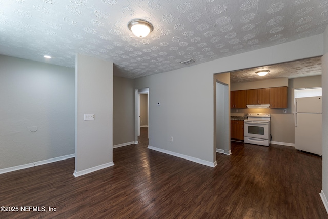 unfurnished living room featuring dark hardwood / wood-style flooring and a textured ceiling