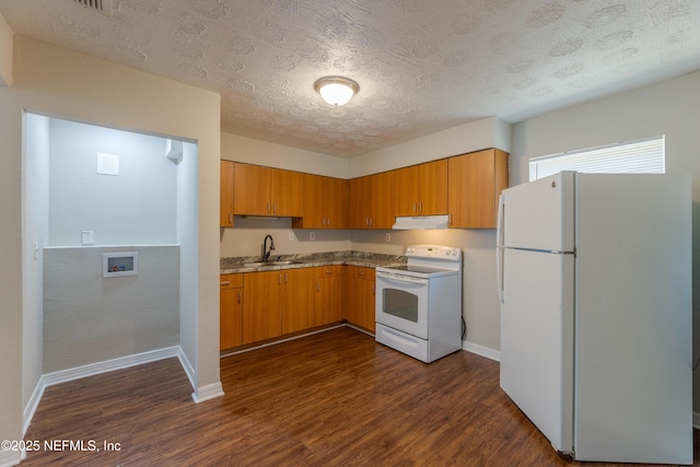 kitchen with white appliances, dark hardwood / wood-style floors, sink, and a textured ceiling