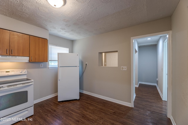 kitchen with white appliances, dark hardwood / wood-style floors, and a textured ceiling