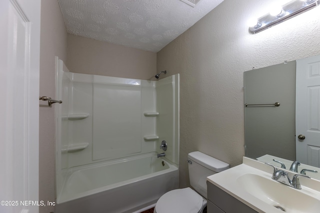 full bathroom featuring vanity, washtub / shower combination, a textured ceiling, and toilet