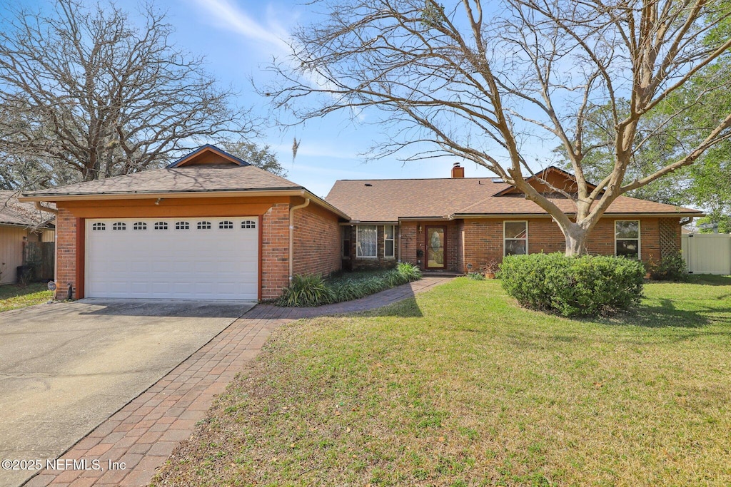 ranch-style home with a garage and a front yard