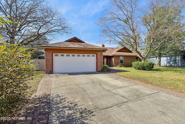 view of front of house featuring a garage and a front lawn