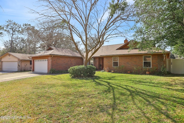 ranch-style home featuring a garage and a front yard