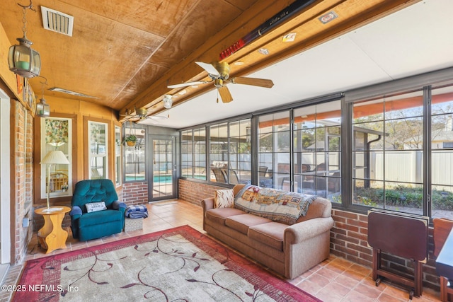 sunroom / solarium featuring ceiling fan