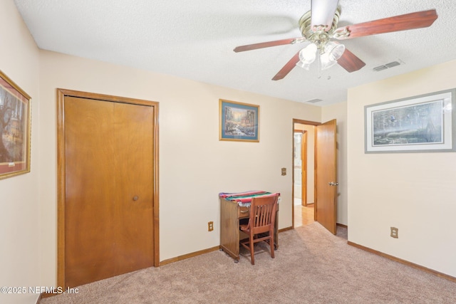 interior space with ceiling fan, a closet, and a textured ceiling