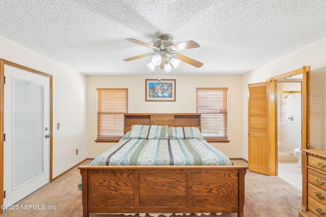 carpeted bedroom featuring ceiling fan, connected bathroom, and a textured ceiling