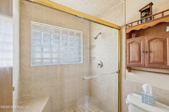 bathroom with toilet and an enclosed shower