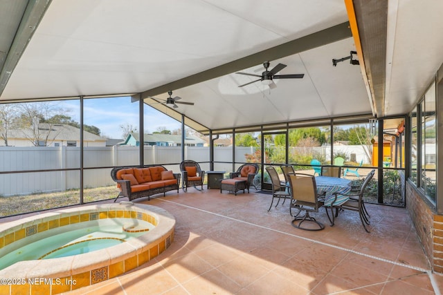 sunroom with ceiling fan, a hot tub, and lofted ceiling with beams