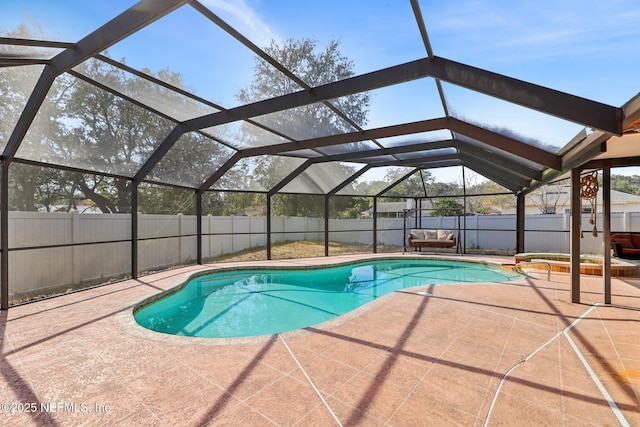 view of swimming pool featuring a lanai and a patio area