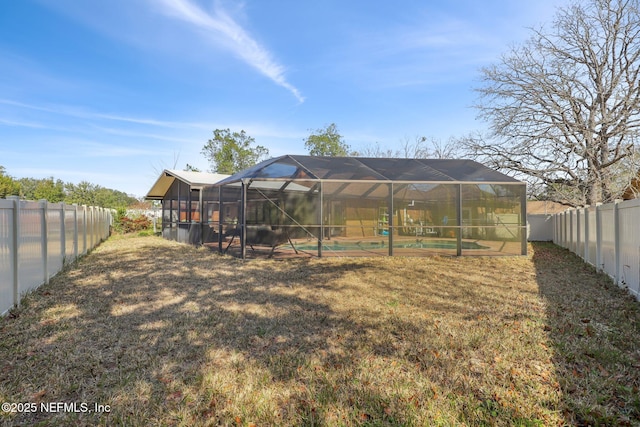 view of yard featuring a fenced in pool and a lanai