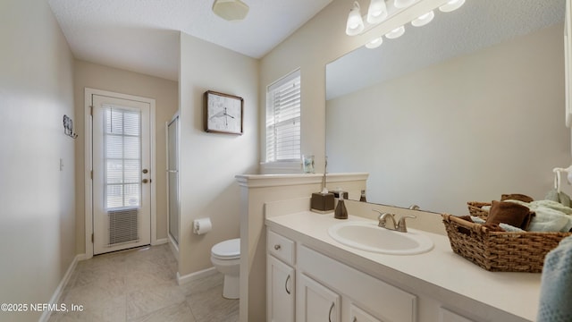 bathroom with vanity, toilet, tile patterned flooring, and a shower with door