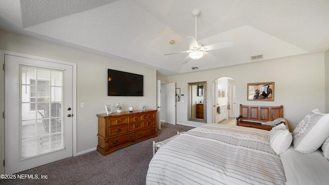 bedroom featuring ceiling fan, carpet floors, a raised ceiling, and a textured ceiling