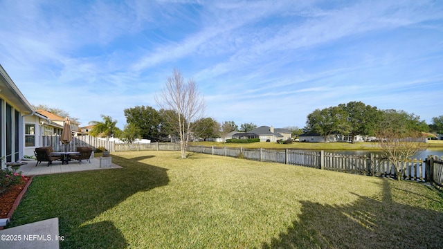 view of yard with a patio and a water view