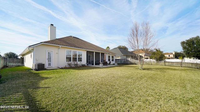 rear view of house featuring central AC, a patio area, and a lawn