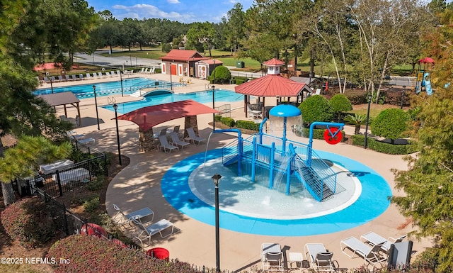 view of swimming pool featuring a gazebo and a playground