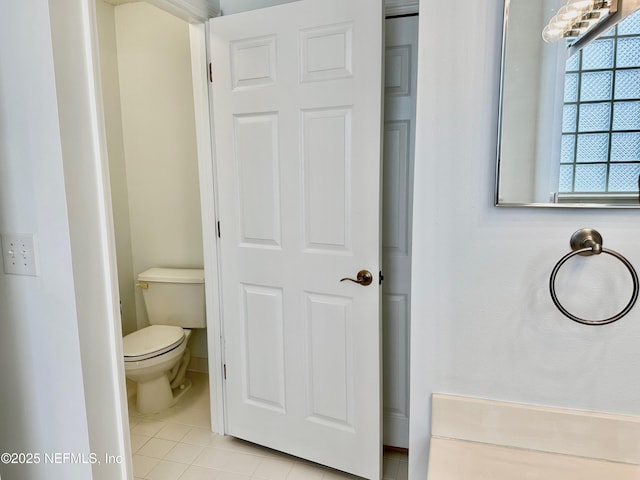 bathroom with toilet and tile patterned flooring