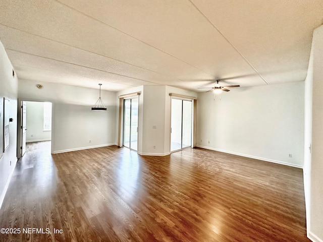 empty room featuring dark hardwood / wood-style floors and ceiling fan