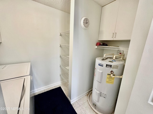 utility room with electric water heater and independent washer and dryer