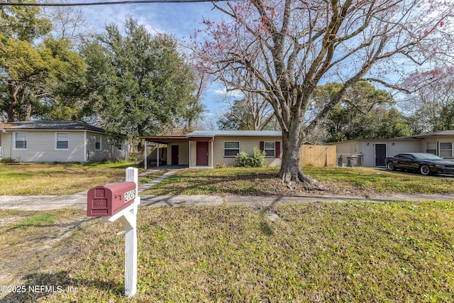 ranch-style house with a front lawn and a carport