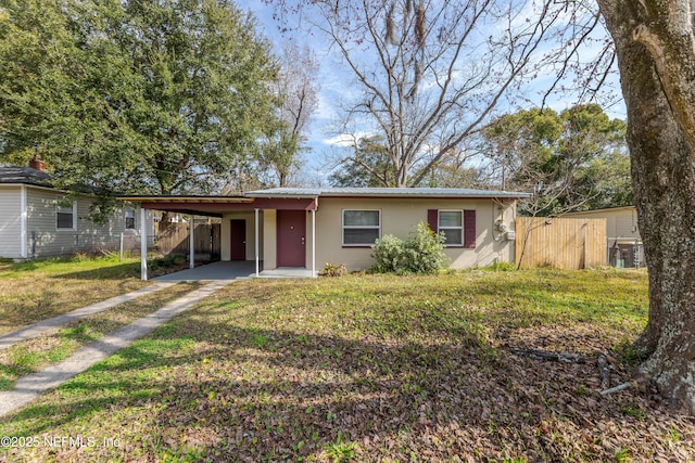 ranch-style house with a carport and a front yard