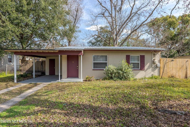 ranch-style home with a front yard and a carport