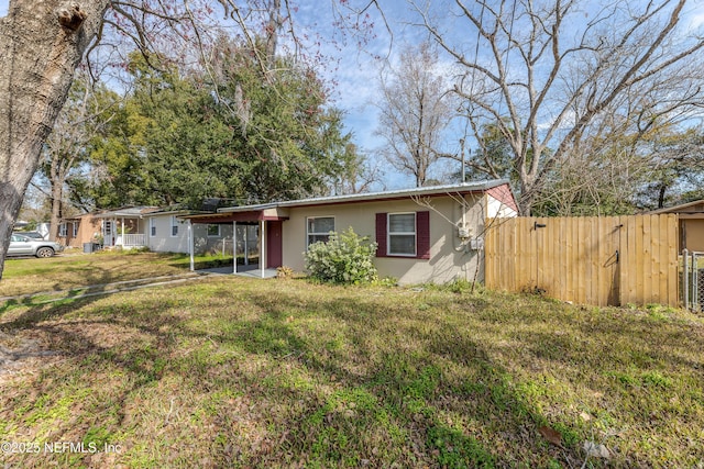 single story home with a carport and a front yard