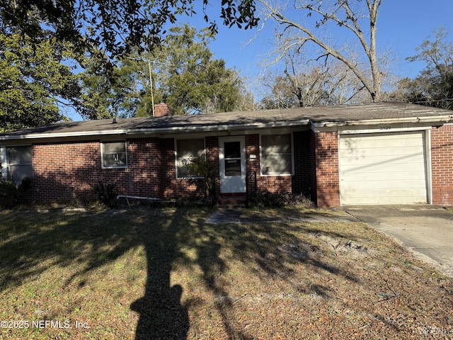 ranch-style home with a garage and a front lawn