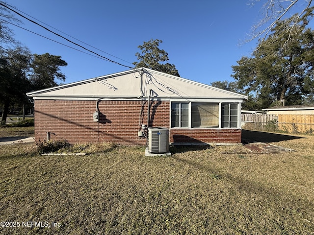 view of home's exterior with a lawn and central air condition unit