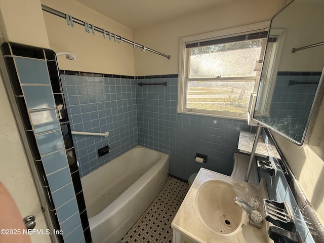 bathroom featuring tile walls, vanity, shower / tub combination, and tile patterned floors