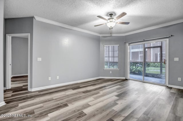 spare room with crown molding, ceiling fan, and wood finished floors