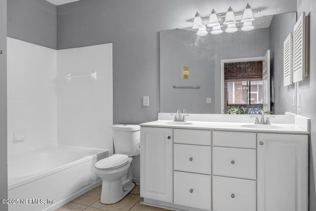 full bath with tile patterned floors, a sink, toilet, and double vanity