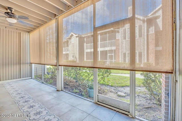 unfurnished sunroom featuring ceiling fan