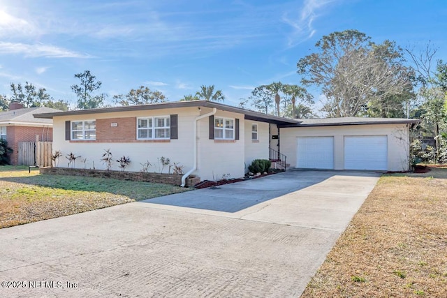 ranch-style home featuring a garage and a front yard