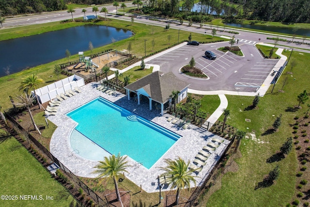 view of pool with a patio area and a water view