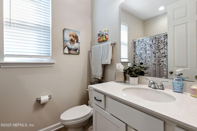 bathroom featuring vanity and toilet