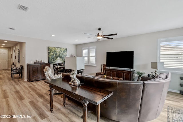 living room featuring ceiling fan and light wood-type flooring