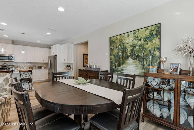 dining area with light wood-type flooring