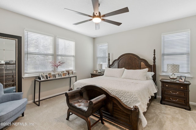 bedroom featuring ceiling fan and light carpet