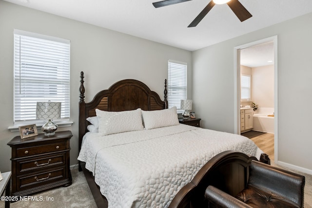 carpeted bedroom with connected bathroom and ceiling fan