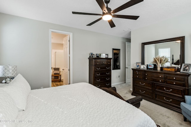 carpeted bedroom with connected bathroom and ceiling fan